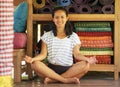 Young beautiful and happy Asian Indonesian woman sitting on wood floor in lotus pose smiling at yoga studio relaxed and zen like Royalty Free Stock Photo