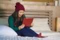 Young beautiful and happy Asian Japanese girl in winter beamy sitting relaxed on bed using laptop computer having fun enjoying onl Royalty Free Stock Photo