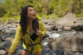 Young beautiful and happy Asian Japanese woman carrying backpack trekking on mountains crossing river enjoying holiday nature and Royalty Free Stock Photo