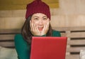 Young beautiful happy Asian Korean girl in winter beamy sitting relaxed on bed using laptop computer having fun enjoying online mo Royalty Free Stock Photo