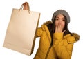 Young beautiful and happy Asian Korean woman in cool winter hat holding shopping bag excited buying Christmas present smiling in Royalty Free Stock Photo