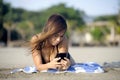 Beautiful and happy Asian woman using mobile phone texting on internet social media smiling relaxed Royalty Free Stock Photo