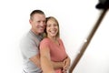 Young beautiful happy and attractive romantic couple with husband and wife or girlfriend and boyfriend taking selfie self portrait