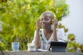 Young beautiful and happy black African American woman enjoying outdoors at cafe working with digital tablet listening to music wi Royalty Free Stock Photo