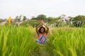 Young beautiful and happy black African American woman sitting at rive field outdoors practicing yoga relaxation and meditation Royalty Free Stock Photo