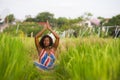 Young beautiful and happy black African American woman sitting at rive field outdoors practicing yoga relaxation and meditation Royalty Free Stock Photo