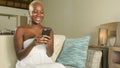 young beautiful and happy black African American woman smiling excited using internet social media app on mobile phone networking Royalty Free Stock Photo