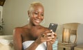 Young beautiful and happy black African American woman smiling excited using internet social media app on mobile phone networking Royalty Free Stock Photo