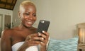 Young beautiful and happy black African American woman smiling excited using internet social media app on mobile phone networking Royalty Free Stock Photo