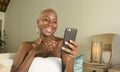 Young beautiful and happy black African American woman smiling excited using internet social media app on mobile phone networking Royalty Free Stock Photo