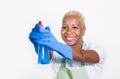 Young beautiful and happy black african american woman using detergent spray bottle as gun smiling playful cleaning and washing ho Royalty Free Stock Photo