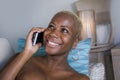 Young beautiful and happy black afro american woman at home couch relaxed smiling cheerful with mobile phone having conversation Royalty Free Stock Photo