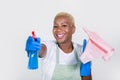 Young beautiful and happy black afro american woman using detergent spray bottle as gun smiling playful cleaning and washing home Royalty Free Stock Photo