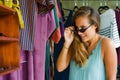 Young beautiful and happy blond woman enjoying shopping trying out clothes and sunglasses in the mirror at vintage and cool beauty Royalty Free Stock Photo