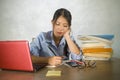 Young beautiful and happy efficient Asian Chinese student girl working on project with laptop computer confident sitting on desk Royalty Free Stock Photo