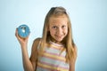 Young beautiful happy and excited blond girl 8 or 9 years old holding donut desert on her hand looking spastic and cheerful in sug