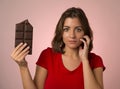 Young beautiful happy and excited woman holding big chocolate ba Royalty Free Stock Photo