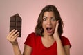 Young beautiful happy and excited woman holding big chocolate ba Royalty Free Stock Photo