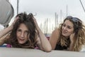 Young, beautiful and happy girl friends laying together on a sail boat Royalty Free Stock Photo