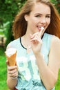 Young beautiful happy girl with long hair in a Sunny day walking around the city and eat ice cream Royalty Free Stock Photo