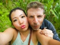 Young beautiful and happy mixed ethnicity couple beautiful Asian Chinese woman and white man in love taking selfie picture Royalty Free Stock Photo