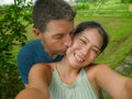Young beautiful and happy mixed ethnicity couple beautiful Asian Chinese woman and white man in love taking selfie picture Royalty Free Stock Photo