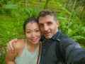 Young beautiful and happy mixed ethnicity couple beautiful Asian Chinese woman and white man in love taking selfie picture Royalty Free Stock Photo