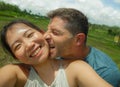 Young beautiful and happy mixed ethnicity couple beautiful Asian Chinese woman and white man in love taking selfie picture Royalty Free Stock Photo