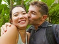 Young beautiful and happy mixed ethnicity couple beautiful Asian Chinese woman and white man in love taking selfie picture Royalty Free Stock Photo