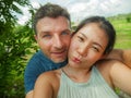 Young beautiful and happy mixed ethnicity couple beautiful Asian Chinese woman and white man in love taking selfie picture Royalty Free Stock Photo