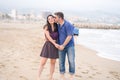 Young beautiful and happy mixed ethnicity couple of Asian woman and Caucasian man relaxed and cheerful walking playful  on beach Royalty Free Stock Photo