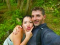 Young beautiful and happy mixed ethnicity couple beautiful Asian Chinese woman and white man in love taking selfie picture Royalty Free Stock Photo