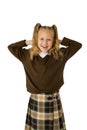 Young beautiful happy schoolgirl in pigtails and uniform smiling happy and excited having fun