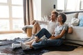 Young beautiful happy smiling interracial couple watching tv together Royalty Free Stock Photo