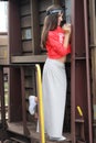 Young beautiful happy teenager girl posing at train station.