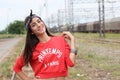 Young beautiful happy teenager girl posing at train station.