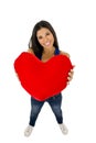 Young beautiful and happy woman holding red cushion heart shape smiling isolated in white Royalty Free Stock Photo