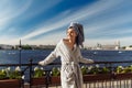 Young beautiful happy woman after a shower in a bathrobe and towel standing on the balcony with a cup of coffee. Cute sexy girl Royalty Free Stock Photo