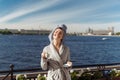 Young beautiful happy woman after a shower in a bathrobe and towel standing on the balcony with a cup of coffee. Cute sexy girl Royalty Free Stock Photo