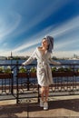 Young beautiful happy woman after a shower in a bathrobe and towel standing on the balcony with a cup of coffee. Cute sexy girl Royalty Free Stock Photo