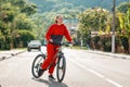 A young beautiful happy woman in sportswear rides a Bicycle. In the background, the road and mountains, a Sunny day. Sports Royalty Free Stock Photo