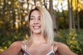 Young beautiful happy woman in a stylish pink dress makes selfie on a smartphone in the forest among the trees Royalty Free Stock Photo