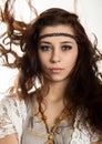 Young beautiful hippie boho woman with fluttering hair having fun poses on a white background Royalty Free Stock Photo