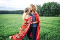 Young beautiful hippie couple walking in green summer field