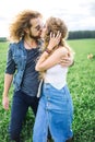 Young beautiful hippie couple walking in green summer field Royalty Free Stock Photo