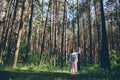 Young beautiful hippie woman walks in the summer forest laughs dances Royalty Free Stock Photo