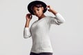 Young beautiful hipster black girl in white sweater and hat Royalty Free Stock Photo