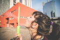 Young beautiful hipster woman bubble blower