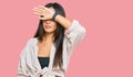 Young beautiful hispanic girl wearing casual clothes covering eyes with arm, looking serious and sad Royalty Free Stock Photo