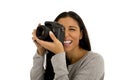 Young beautiful hispanic photographer woman smiling happy taking photo with reflex camera